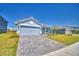 Charming single-story home featuring a paver driveway, a two-car garage, and well-maintained landscaping at 4670 Grandview Glen Dr, Auburndale, FL 33823