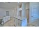 Open-concept kitchen with granite island, white cabinetry, stainless steel appliances, and wood-look tile flooring at 4670 Grandview Glen Dr, Auburndale, FL 33823