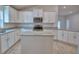 Spacious kitchen with white cabinets, granite countertops, stainless steel appliances, and center island at 4670 Grandview Glen Dr, Auburndale, FL 33823