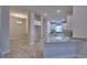 Bright open kitchen with granite countertops, white cabinets, and a view to the dining area at 4670 Grandview Glen Dr, Auburndale, FL 33823