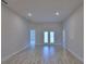 The neutral living space has an open floorplan with recessed lighting and doors leading to the backyard at 4670 Grandview Glen Dr, Auburndale, FL 33823