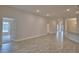Open-concept living area with recessed lighting and wood-look tile flooring with a view to the hallway at 4670 Grandview Glen Dr, Auburndale, FL 33823