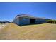 Spacious backyard featuring lush lawn and covered patio, great for outdoor enjoyment at 4938 Vue Delac Pass, Auburndale, FL 33823