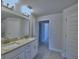 Bright bathroom featuring granite countertops, double vanity, and tiled shower-tub combination at 4938 Vue Delac Pass, Auburndale, FL 33823