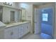 Bright bathroom with double vanity, granite countertop, and tile flooring at 4938 Vue Delac Pass, Auburndale, FL 33823