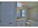 Bright bathroom featuring granite countertop, modern vanity and tiled shower-tub combination at 4938 Vue Delac Pass, Auburndale, FL 33823