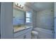 Bright bathroom featuring granite countertop, modern vanity and tiled shower-tub combination at 4938 Vue Delac Pass, Auburndale, FL 33823