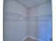 Walk-in closet with ample storage, including multiple wire shelves for organization at 4938 Vue Delac Pass, Auburndale, FL 33823