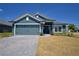 Beautiful one story home featuring a two car garage, tiled roof and well manicured lawn at 4938 Vue Delac Pass, Auburndale, FL 33823