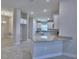 Modern kitchen with white cabinetry and stainless steel appliances, open to dining area at 4938 Vue Delac Pass, Auburndale, FL 33823