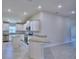 Modern kitchen featuring white cabinetry, stainless steel appliances, and granite countertops at 4938 Vue Delac Pass, Auburndale, FL 33823