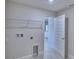 Spacious laundry room with utility connections and access to additional storage area at 4938 Vue Delac Pass, Auburndale, FL 33823