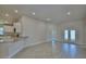 Open-concept living room with tile floors, recessed lighting, and glass doors to the outside at 4938 Vue Delac Pass, Auburndale, FL 33823