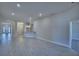 Spacious living room with tile flooring, recessed lights, and an open view to the kitchen at 4938 Vue Delac Pass, Auburndale, FL 33823