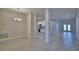 Open-concept living space with tile flooring and view of the modern kitchen at 4938 Vue Delac Pass, Auburndale, FL 33823