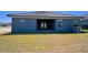 A single-Gathering home features a covered patio, well-kept lawn, and tasteful exterior paint at 4938 Vue Delac Pass, Auburndale, FL 33823