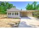 Charming single-story home featuring a carport, neutral paint, and landscaping with sunny curb appeal at 318 Senate St, Auburndale, FL 33823
