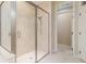 Modern bathroom featuring a glass-enclosed shower with tiled walls and floor at 8288 Lake James Dr, Lakeland, FL 33810