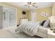 Brightly lit bedroom with a ceiling fan, sliding glass doors, and an ensuite bathroom at 8288 Lake James Dr, Lakeland, FL 33810