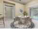 Cozy dining area with a view of the backyard, featuring a round table and comfortable seating, perfect for casual dining at 8288 Lake James Dr, Lakeland, FL 33810