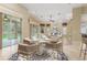Bright dining area with a round table, comfortable chairs, and sliding glass doors, ideal for Gathering meals and gatherings at 8288 Lake James Dr, Lakeland, FL 33810