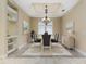 Elegant dining room with a chandelier, a sideboard, and stylish decor, creating a sophisticated space for formal dinners at 8288 Lake James Dr, Lakeland, FL 33810