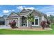 Charming home exterior with stone accents, lush landscaping, and a well-manicured lawn, creating a welcoming curb appeal at 8288 Lake James Dr, Lakeland, FL 33810
