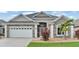Beautiful home with a well-maintained lawn, a two-car garage, and a welcoming front entrance, perfect for Gathering living at 8288 Lake James Dr, Lakeland, FL 33810