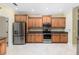Kitchen with wood cabinets, stainless steel appliances, and ample counter space at 8288 Lake James Dr, Lakeland, FL 33810