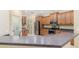 Kitchen featuring wood cabinets, stainless steel appliances and dark countertops at 8288 Lake James Dr, Lakeland, FL 33810