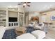 Spacious living room with built-in shelves, a ceiling fan, and stylish furniture, creating a comfortable and inviting atmosphere at 8288 Lake James Dr, Lakeland, FL 33810