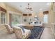 Cozy living room with a ceiling fan, a comfortable sofa, and large windows, perfect for relaxing and entertaining guests at 8288 Lake James Dr, Lakeland, FL 33810