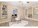 Bright office features built-in shelving, wood floors, and French doors to an adjacent room at 8288 Lake James Dr, Lakeland, FL 33810