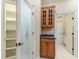 Walk-in pantry with shelving and a decorative glass door, adjacent to cabinetry and bathroom at 8288 Lake James Dr, Lakeland, FL 33810