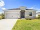 Inviting single-story home with a well-manicured lawn and a two-car garage at 2101 Summerlake Dr, Auburndale, FL 33823