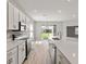 Modern kitchen featuring white cabinets, stainless steel appliances, and an open layout at 2101 Summerlake Dr, Auburndale, FL 33823