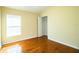 Bright secondary bedroom with hardwood floors and a closet at 3717 Huntington Ln, Winter Haven, FL 33884