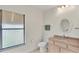 Bathroom featuring a large window, neutral tile, and traditional fixtures at 5879 Swallow Dr, Lakeland, FL 33809