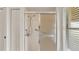 Bathroom shower featuring a glass door, safety bars, and tile surround at 5879 Swallow Dr, Lakeland, FL 33809