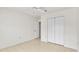 Bright bedroom featuring tile floors, a closet, and light color scheme at 5879 Swallow Dr, Lakeland, FL 33809