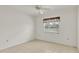 Bright bedroom featuring tile floors, a ceiling fan, and light color scheme at 5879 Swallow Dr, Lakeland, FL 33809