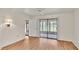 Bright bedroom featuring wood floors, fan, and sliding glass doors to the lanai at 5879 Swallow Dr, Lakeland, FL 33809