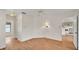 Bedroom with wood floors, a ceiling fan, and a doorway view to the kitchen at 5879 Swallow Dr, Lakeland, FL 33809