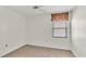 Bedroom featuring carpeted floors, a window, and light color scheme at 5879 Swallow Dr, Lakeland, FL 33809