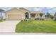 Inviting front yard with well-manicured lawn and neutral-toned single-Gathering home with a tan driveway at 5879 Swallow Dr, Lakeland, FL 33809