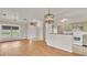 Open-concept living area with wood floors and a view of kitchen, perfect for modern living at 5879 Swallow Dr, Lakeland, FL 33809