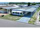 Mobile home with carport and mature landscaping at 6734 Kensington Ne Dr, Winter Haven, FL 33881