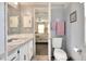 Clean bathroom with toilet, sink, and vanity at 6734 Kensington Ne Dr, Winter Haven, FL 33881
