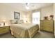 Bright bedroom with double bed and dresser at 6734 Kensington Ne Dr, Winter Haven, FL 33881