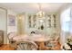 Bright dining area with built-in hutch and chandelier at 6734 Kensington Ne Dr, Winter Haven, FL 33881